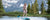 Woman paddle boarding on a lake with a mountain view