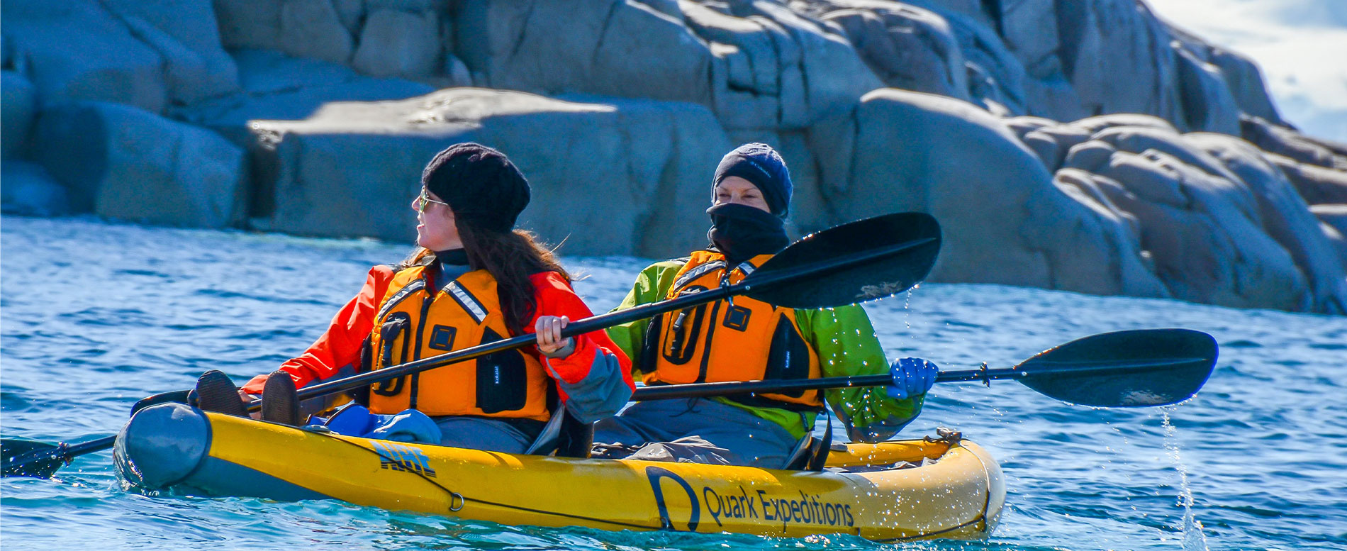 Two people on a kayak dressed correctly