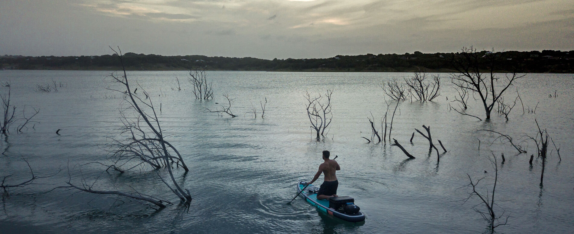 Man paddle boarding at night