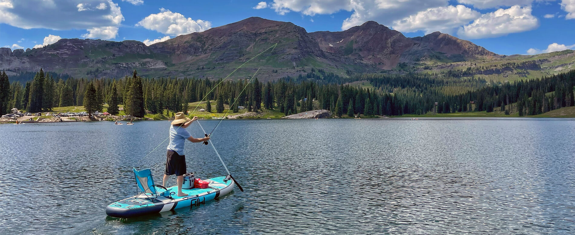 man sup fly fishing on a blue GILI inflatable paddle board