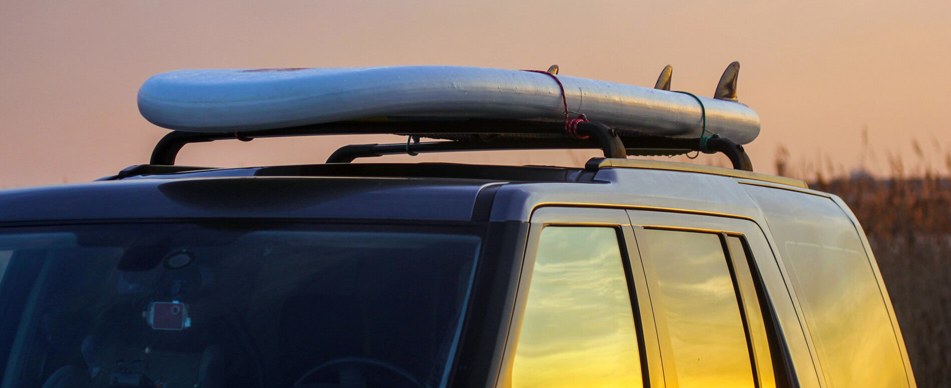 Paddle board strap on a car