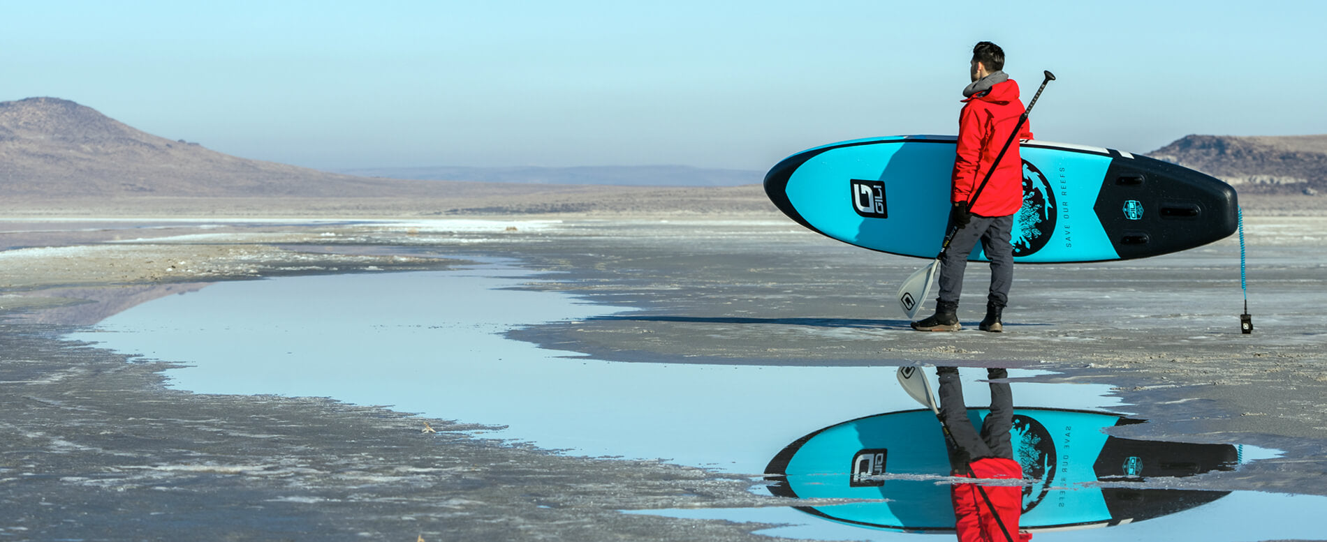 Man carrying his adventure inflatable paddle board